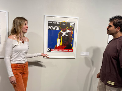 Two people talking and looking at art