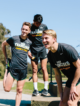 Women's cross country team members stretch