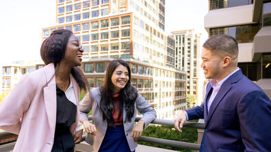 three students laughing together at downtown campus