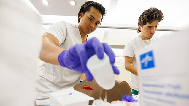 nursing students hold supplies