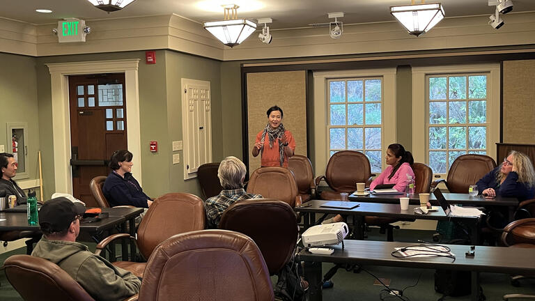 Professor speaking to a room of other faculty members