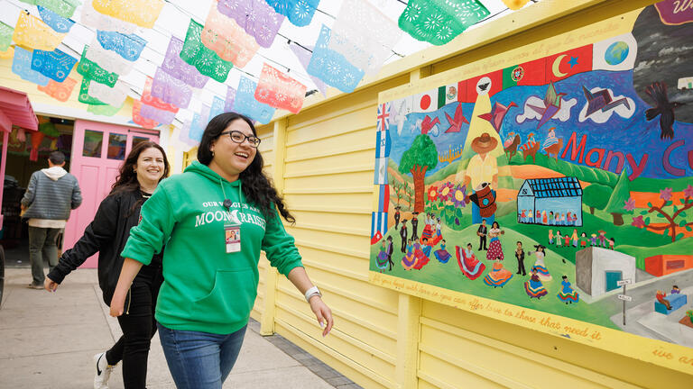 student walks down a colorful hallway at Ayudando Latinos a Soñar in Half Moon Bay