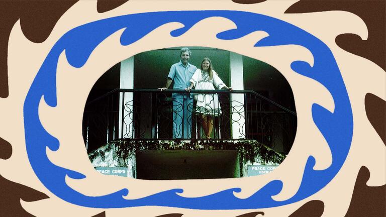 Dennis and Pam Lucey beam at the camera from a balcony in Liberia.
