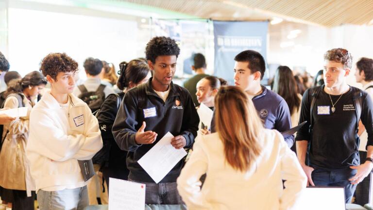 Students chatting with an employer.
