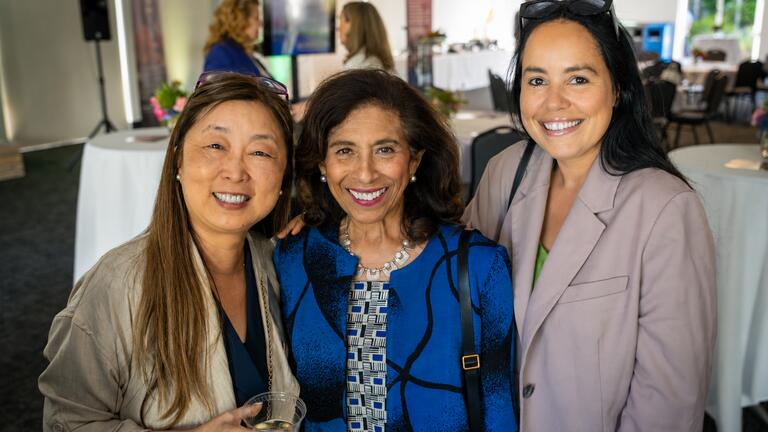 attendees smile together during event