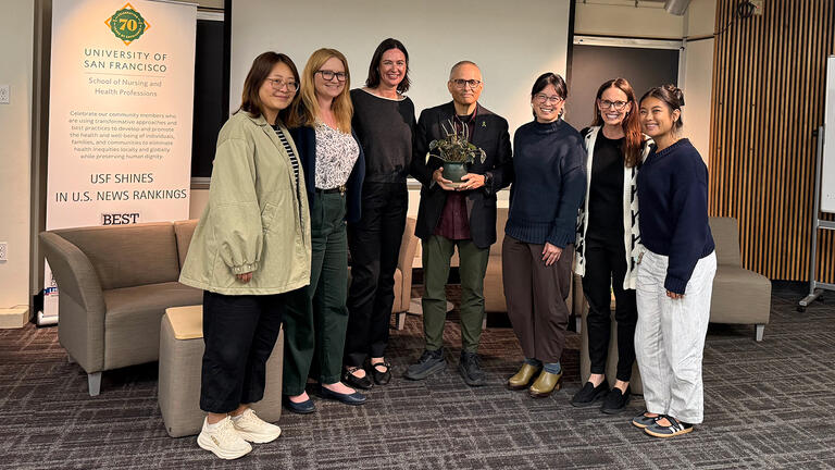 Dr. Tomás J. Aragón poses with plant for a group photo with event attendees