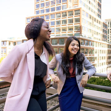 three students laughing together at downtown campus
