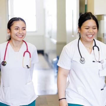 Two nursing students in scrubs
