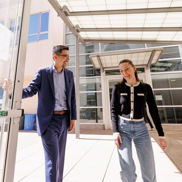 Professor holding door for student