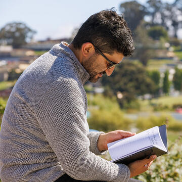 students looks down at notebook in San Francisco's Bayview neighborhood