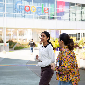 Two USF students walking outside the Google office