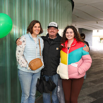 USF student posing with parents