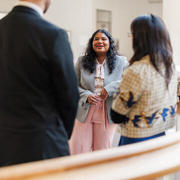 women smiles while speaking to others
