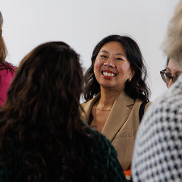 faculty member laughing in a crowd