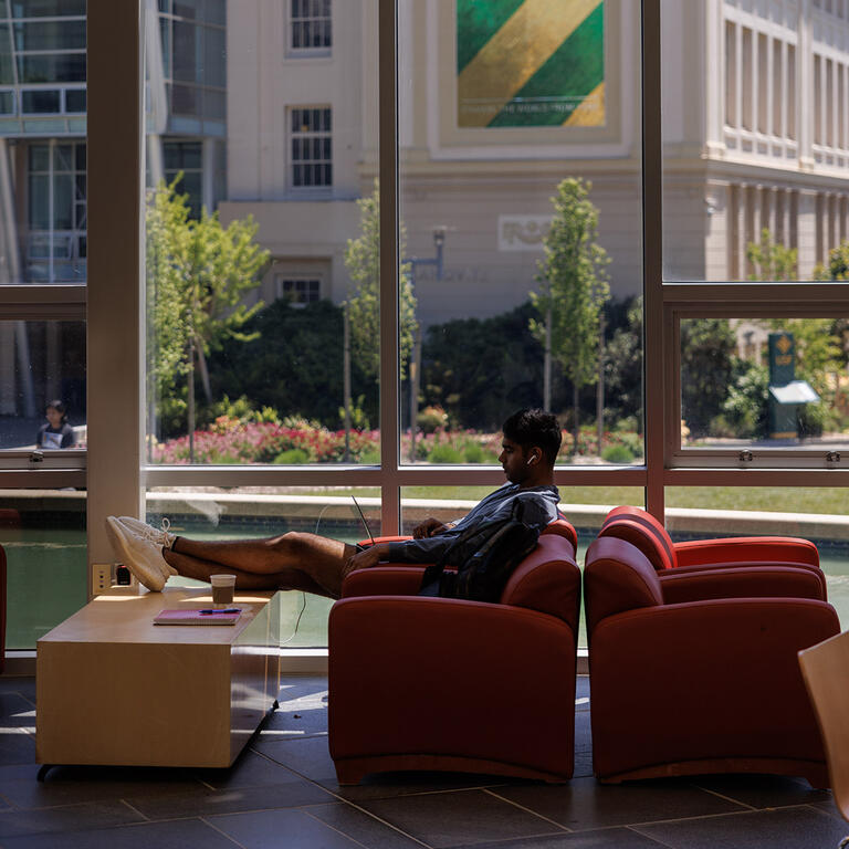 student studies at gleeson library