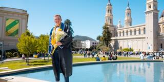 USF student standing near reflecting pool